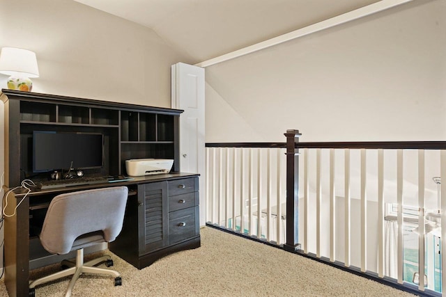 carpeted home office with vaulted ceiling