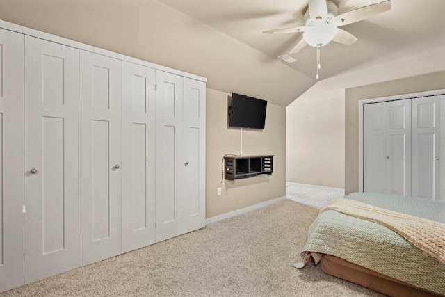 bedroom with vaulted ceiling, ceiling fan, and carpet flooring