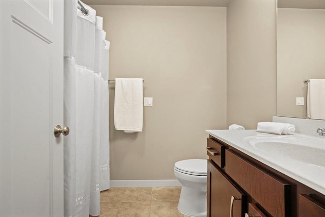 bathroom with tile patterned floors, vanity, and toilet