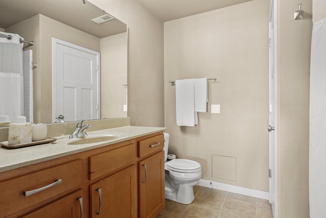 bathroom featuring tile patterned flooring, vanity, and toilet