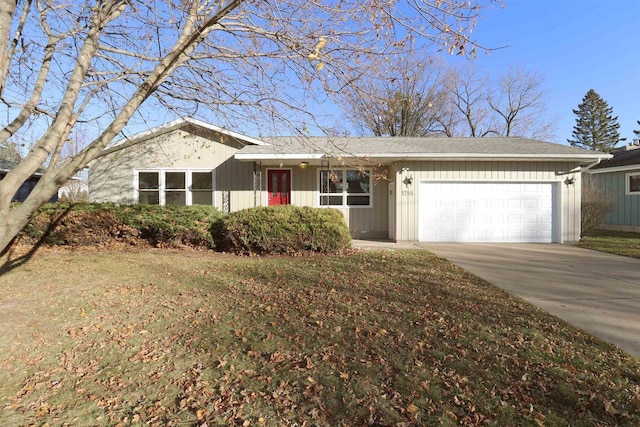 single story home featuring a front yard and a garage