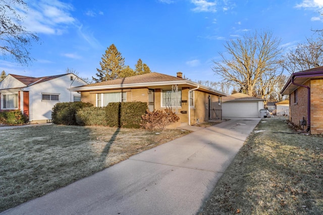 view of front of house featuring an outbuilding, a front yard, and a garage