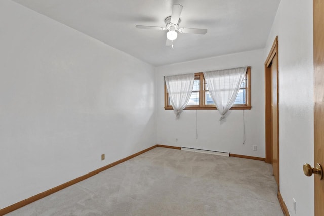 unfurnished room with light carpet, baseboard heating, and ceiling fan