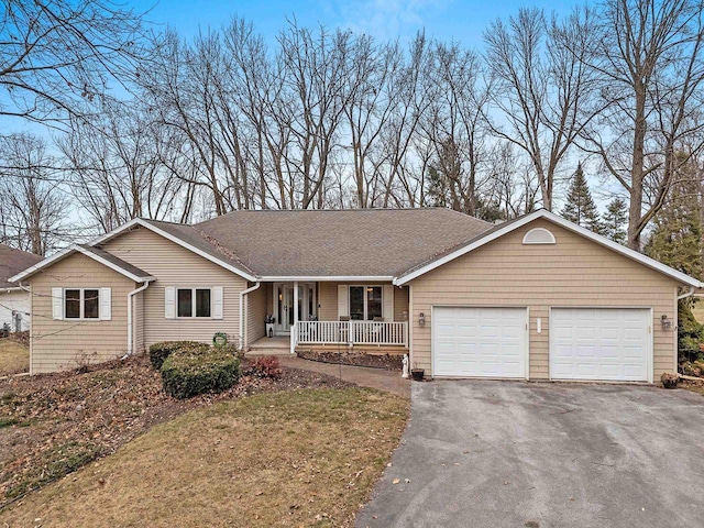 single story home with a garage and covered porch