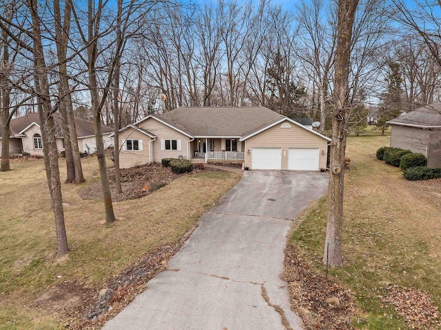 ranch-style home with covered porch, a front lawn, and a garage