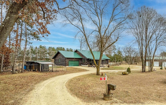 log-style house with a garage