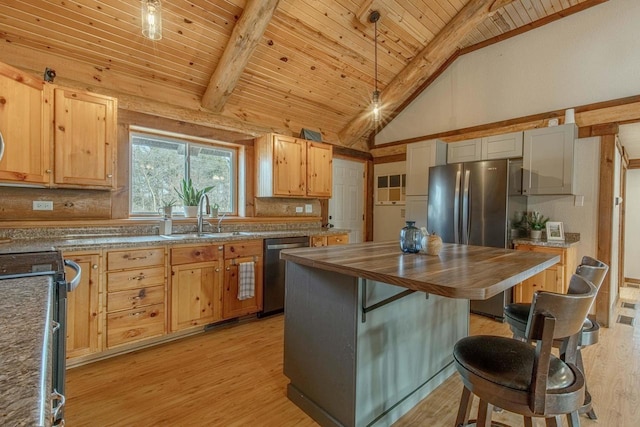 kitchen with appliances with stainless steel finishes, pendant lighting, high vaulted ceiling, sink, and tasteful backsplash