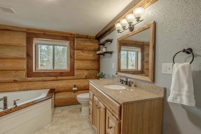 bathroom featuring a washtub, toilet, vanity, a textured ceiling, and rustic walls