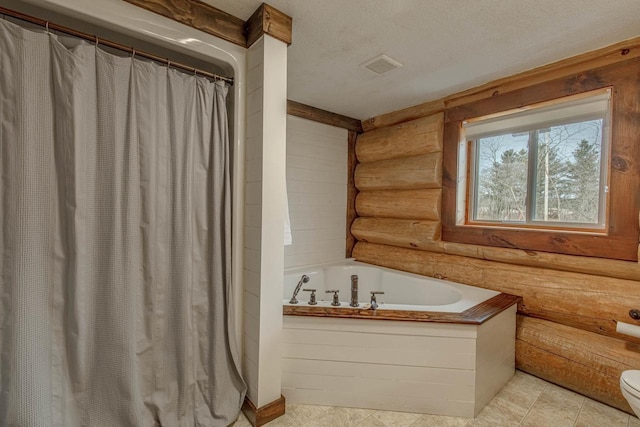 bathroom featuring toilet, rustic walls, a textured ceiling, and a tub to relax in