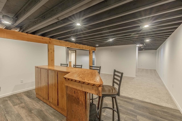 bar featuring dark hardwood / wood-style flooring