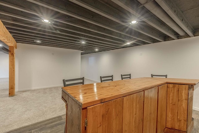 bar featuring dark carpet and wooden counters