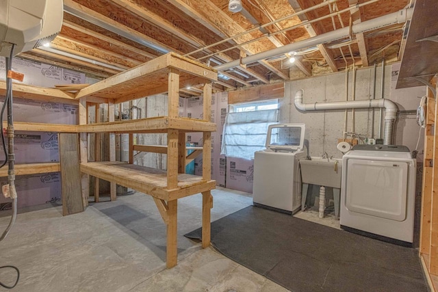 basement with sink and washer and clothes dryer