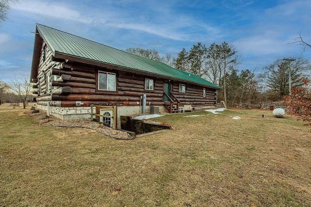 view of side of home with a lawn