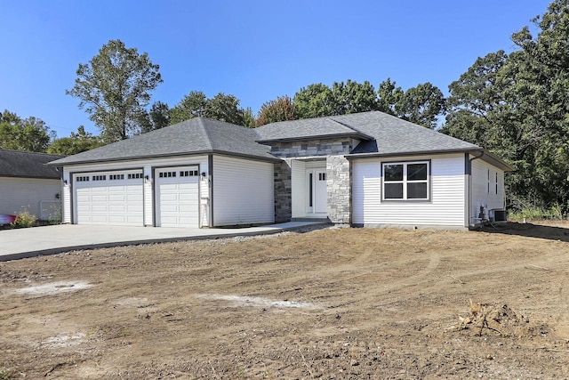 view of front facade with a garage and central AC unit