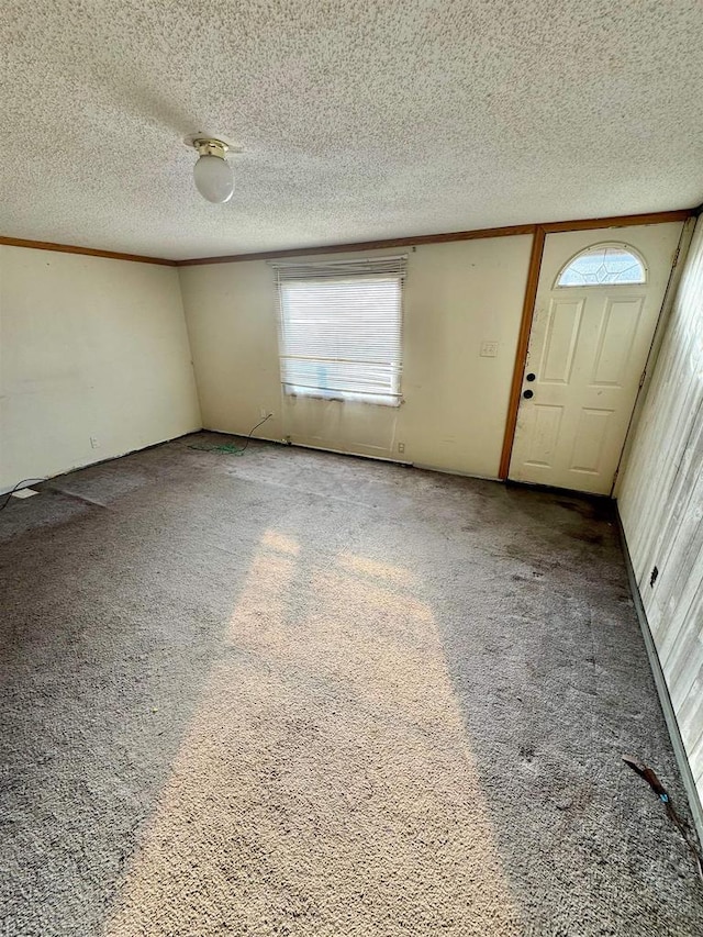 interior space featuring a textured ceiling and carpet