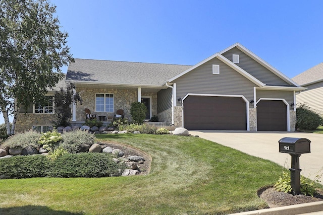 view of front of house with a front yard and a garage