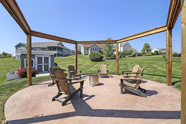 view of patio / terrace with a fire pit and a shed