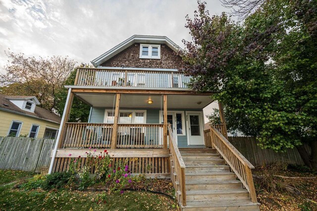 view of front of home with a porch and a balcony