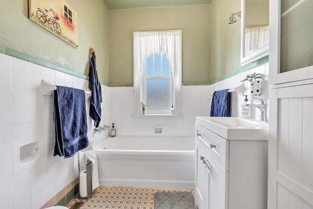 bathroom featuring a tub, tile patterned floors, and vanity