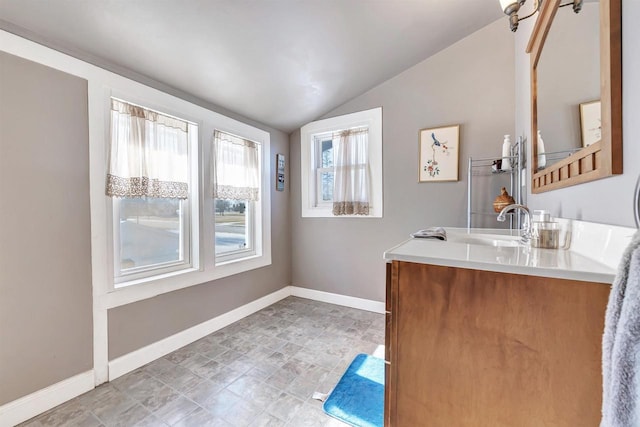 bathroom with lofted ceiling and vanity