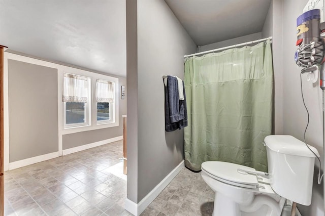 bathroom with toilet and a shower with curtain