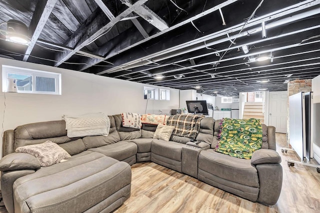 living room featuring plenty of natural light and hardwood / wood-style flooring