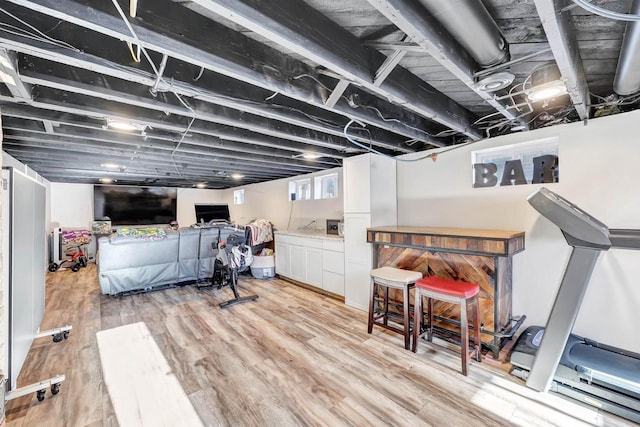 exercise room featuring light hardwood / wood-style floors