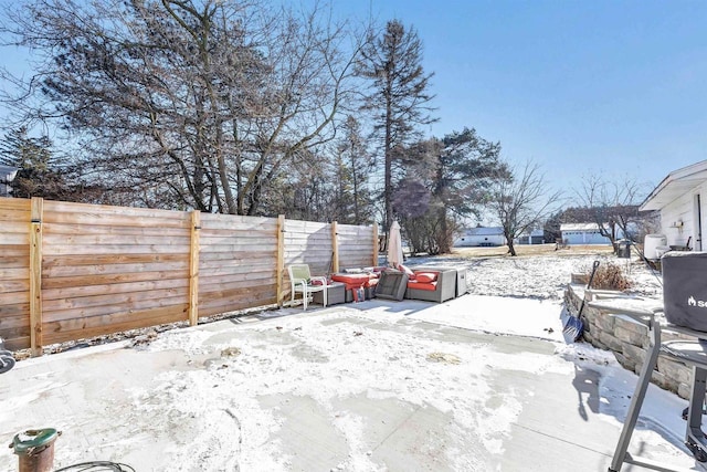 yard covered in snow with a patio