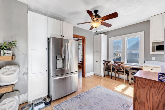 kitchen with white cabinets, ceiling fan, light hardwood / wood-style flooring, and stainless steel refrigerator with ice dispenser