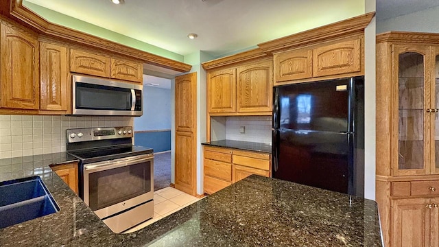 kitchen featuring sink, stainless steel appliances, backsplash, and light tile patterned floors