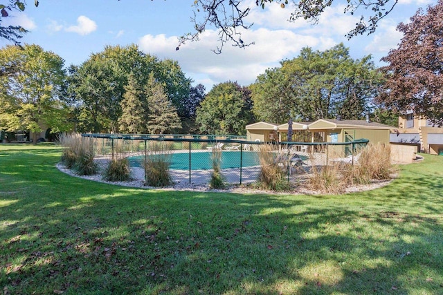 view of pool featuring a lawn