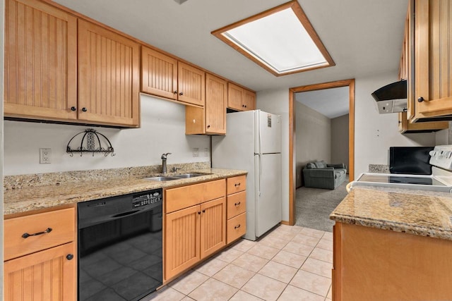 kitchen featuring white fridge, dishwasher, range, light tile patterned floors, and sink