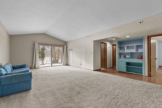 carpeted living room featuring lofted ceiling