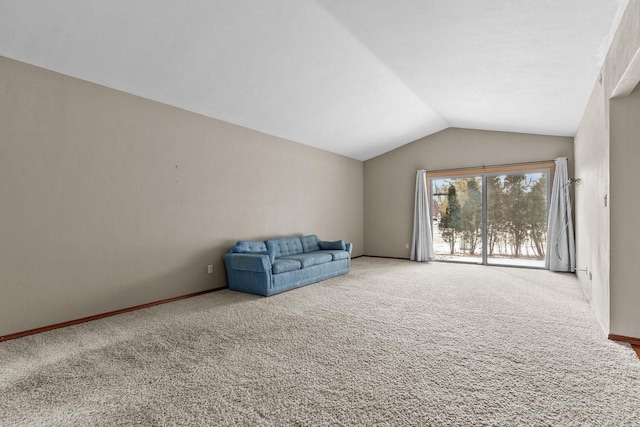 unfurnished room featuring vaulted ceiling and carpet flooring