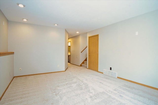 unfurnished room with light carpet