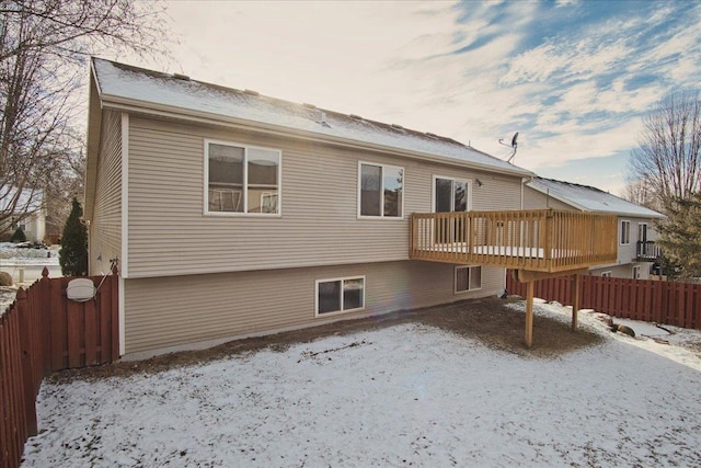 snow covered property with a deck