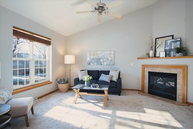 carpeted living room with a fireplace, ceiling fan, and vaulted ceiling