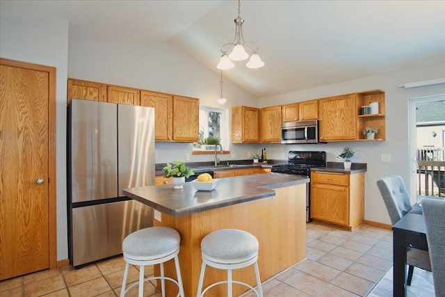 kitchen featuring stainless steel appliances, a kitchen breakfast bar, a kitchen island, a chandelier, and pendant lighting