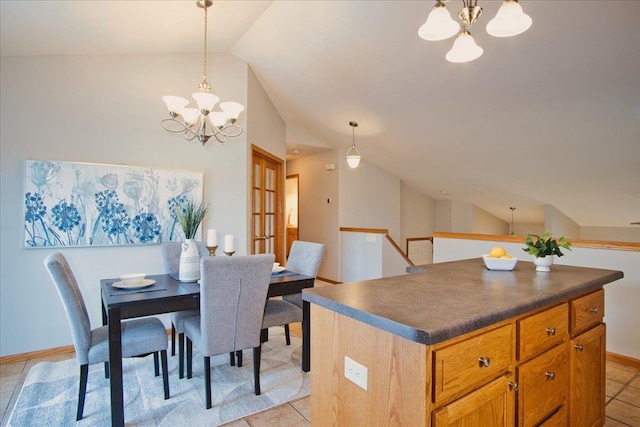 dining room featuring lofted ceiling, light tile patterned floors, and a notable chandelier