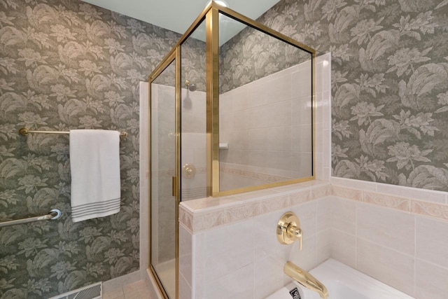 bathroom with walk in shower and tile patterned flooring