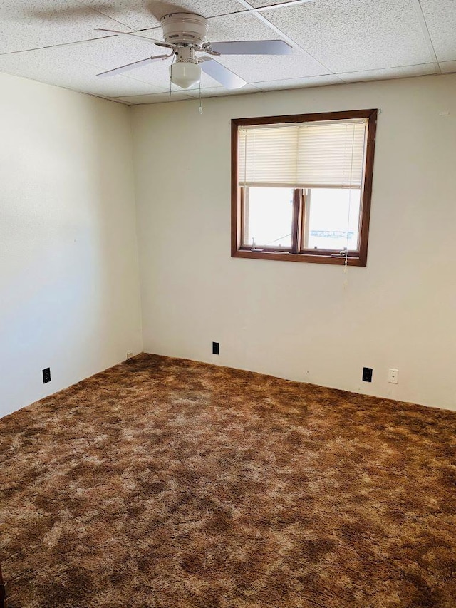 spare room featuring ceiling fan and carpet