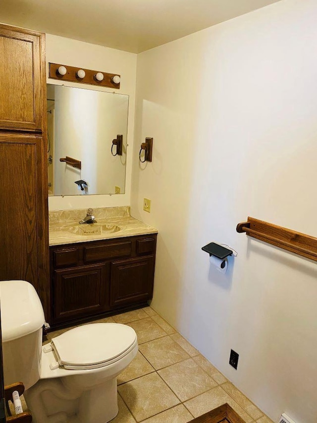 bathroom featuring toilet, vanity, and tile patterned flooring