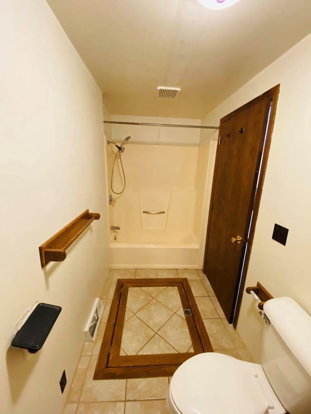 bathroom featuring tile patterned flooring, bathtub / shower combination, and toilet