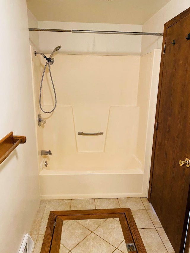 bathroom featuring tile patterned flooring and shower / tub combination