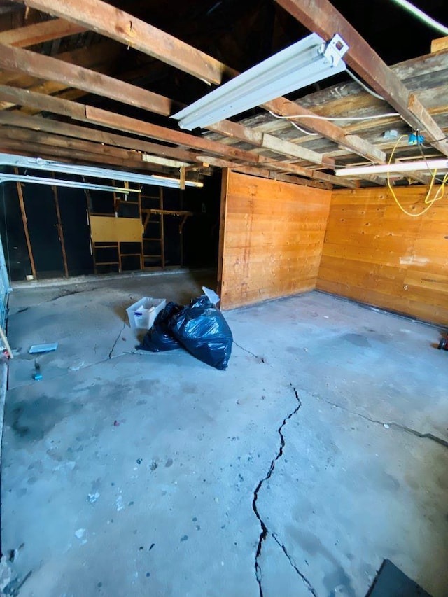 garage featuring wood walls