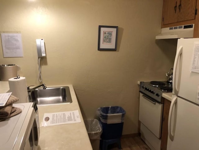 kitchen featuring white appliances and sink