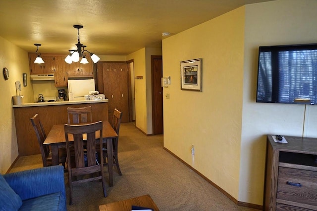 dining space featuring a notable chandelier and light colored carpet