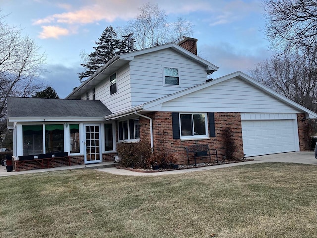 view of front of home with a garage and a front lawn