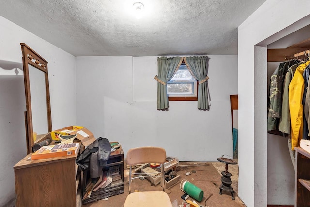 interior space with a closet and a textured ceiling