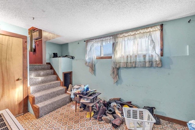 stairway with a textured ceiling